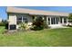 Spacious backyard featuring lush green grass and a screened lanai at 18418 Bent Pine Dr, Hudson, FL 34667