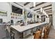 Upscale bar with a quartz countertop, TV's for entertainment, liquor shelving and wooden bar stools at 18418 Bent Pine Dr, Hudson, FL 34667