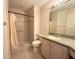 Bathroom featuring a tiled shower with grab bar, vanity with sink, and neutral decor at 18418 Bent Pine Dr, Hudson, FL 34667