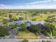 Aerial view of the community clubhouse showcasing ample parking, mature trees, and access to community amenities at 18418 Bent Pine Dr, Hudson, FL 34667