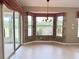 Bright dining room with bay window, chandelier, and sliding glass doors to outdoor patio at 18418 Bent Pine Dr, Hudson, FL 34667