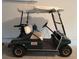 Clean, oversized green Club Car Golf Cart is parked inside a spacious residential garage at 18418 Bent Pine Dr, Hudson, FL 34667