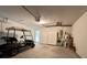 Spacious garage with golf cart, storage, overhead lighting, and a large door to the exterior at 18418 Bent Pine Dr, Hudson, FL 34667
