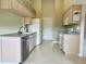 Spacious kitchen featuring ample cabinet space, a sink, and modern appliances at 18418 Bent Pine Dr, Hudson, FL 34667