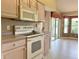Well-equipped kitchen featuring an oven, microwave, and adjacent breakfast nook with a view at 18418 Bent Pine Dr, Hudson, FL 34667