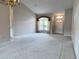 Bright living room with a large window and chandelier, offering ample space and natural light at 18418 Bent Pine Dr, Hudson, FL 34667