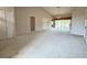 Bright living room with carpet flooring, featuring an open layout with vaulted ceilings and slider access to backyard at 18418 Bent Pine Dr, Hudson, FL 34667