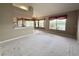 Open-concept living room featuring natural light and view of the kitchen and dining room at 18418 Bent Pine Dr, Hudson, FL 34667
