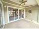 Cozy sunroom with neutral rug, fan, and sliding glass doors that offer backyard views at 18418 Bent Pine Dr, Hudson, FL 34667
