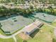 Aerial view of the community tennis courts and covered seating area, perfect for friendly matches at 18418 Bent Pine Dr, Hudson, FL 34667