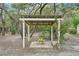 Backyard gazebo featuring simple wood construction and surrounding trees and foliage at 18633 Oak Way Dr, Hudson, FL 34667