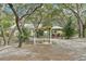 This backyard offers a serene retreat with mature trees, gazebo and covered area for entertaining at 18633 Oak Way Dr, Hudson, FL 34667