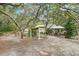 A tranquil backyard featuring mature trees and a gazebo and covered area, perfect for entertaining guests at 18633 Oak Way Dr, Hudson, FL 34667