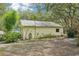Exterior view of the home showcasing backyard with mature trees and well-maintained surroundings at 18633 Oak Way Dr, Hudson, FL 34667
