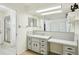 Bathroom featuring a vanity with built-in makeup desk and large mirrors at 18633 Oak Way Dr, Hudson, FL 34667