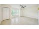 Well-lit bedroom featuring tile flooring, a ceiling fan, and ample closet space at 18633 Oak Way Dr, Hudson, FL 34667