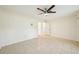 Bright bedroom features tile flooring, a ceiling fan, and two closets at 18633 Oak Way Dr, Hudson, FL 34667