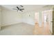 Spacious bedroom with tile flooring, ceiling fan, and doorway to en-suite bathroom at 18633 Oak Way Dr, Hudson, FL 34667