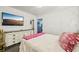 Bright bedroom with a TV, a dresser and a glimpse into other rooms, offering a comfortable and connected living experience at 18633 Oak Way Dr, Hudson, FL 34667