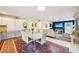 Bright open-concept dining area into the living room showcasing a marble-top table and a transition to a modern kitchen at 18633 Oak Way Dr, Hudson, FL 34667