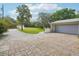 A driveway with block pavers leading up to a home's garage and front yard at 18633 Oak Way Dr, Hudson, FL 34667