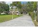 Long driveway leading up to the house, flanked by lamp posts and lush greenery at 18633 Oak Way Dr, Hudson, FL 34667
