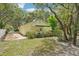 Backyard area with dining area on the deck and foliage all around at 18633 Oak Way Dr, Hudson, FL 34667