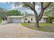 A one-story home featuring a gray garage door and a driveway with block pavers at 18633 Oak Way Dr, Hudson, FL 34667