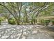Exterior driveway and canopy with foliage and trees surrounding the area at 18633 Oak Way Dr, Hudson, FL 34667