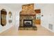 Beautiful stone fireplace with a wooden mantle, open to other living areas at 18633 Oak Way Dr, Hudson, FL 34667