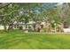 Charming single-story home with stone accents, mature trees, and lush landscaping on a spacious lot at 18633 Oak Way Dr, Hudson, FL 34667