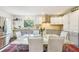 Bright kitchen featuring a stainless fridge, window view, and eat-in area with a marble table at 18633 Oak Way Dr, Hudson, FL 34667