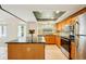 Bright eat-in kitchen with recessed lighting, stainless steel appliances, and black marble island at 18633 Oak Way Dr, Hudson, FL 34667