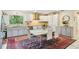 Updated kitchen featuring modern appliances, stylish cabinetry, a marble dining table, and a sunlit window at 18633 Oak Way Dr, Hudson, FL 34667