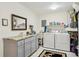 This functional laundry room includes appliances, storage, and a sink for convenience at 18633 Oak Way Dr, Hudson, FL 34667