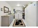 Efficient laundry room equipped with modern appliances, ample counter space, and storage solutions at 18633 Oak Way Dr, Hudson, FL 34667