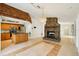 View of open floor plan with kitchen, dining area, and striking stone fireplace at 18633 Oak Way Dr, Hudson, FL 34667