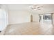 Bright living room with neutral tile flooring and sliding glass doors to the pool area at 18633 Oak Way Dr, Hudson, FL 34667