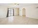 Spacious living room with sliding glass doors and tile flooring at 18633 Oak Way Dr, Hudson, FL 34667