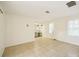 Spacious living room showcasing tile floors, natural light, and a built-in desk area at 18633 Oak Way Dr, Hudson, FL 34667