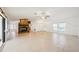 Open living room features a stone fireplace and neutral tile flooring throughout at 18633 Oak Way Dr, Hudson, FL 34667