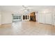 Large living room includes stone fireplace, tile floors, and sliding glass doors to pool at 18633 Oak Way Dr, Hudson, FL 34667