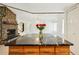 Open living room with stone fireplace and black marble kitchen island in the foreground at 18633 Oak Way Dr, Hudson, FL 34667