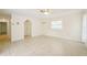 Bright living room with tile floors and view to hallway at 18633 Oak Way Dr, Hudson, FL 34667