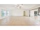 Bright living room with neutral tile flooring and sliding glass doors at 18633 Oak Way Dr, Hudson, FL 34667