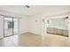 Spacious room with tile flooring, connecting to a bathroom and outdoor patio area at 18633 Oak Way Dr, Hudson, FL 34667