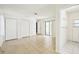 Main bedroom with tiled floors, ample closet space, sliding door, and en suite bathroom access at 18633 Oak Way Dr, Hudson, FL 34667
