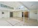 A covered patio with neutral tile flooring and windows that look out to the backyard at 18633 Oak Way Dr, Hudson, FL 34667