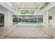 Bright screened pool area featuring a tile floor, a white roof and a beautiful view of the backyard at 18633 Oak Way Dr, Hudson, FL 34667