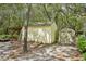 Exterior shed with other various storage buildings with foliage at 18633 Oak Way Dr, Hudson, FL 34667